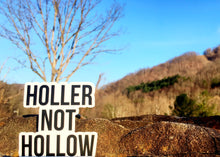 Holler Not Hollow Sticker in front of an outdoor view.